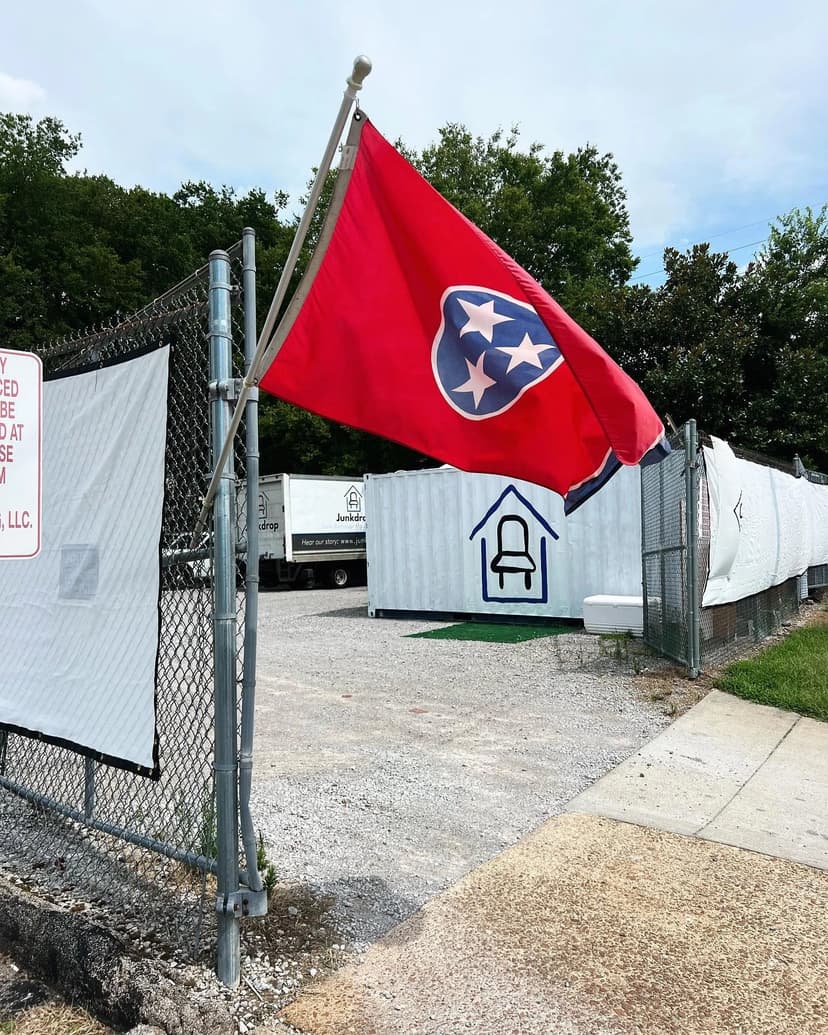 Junkdrop yard with Tennessee flag and containers
