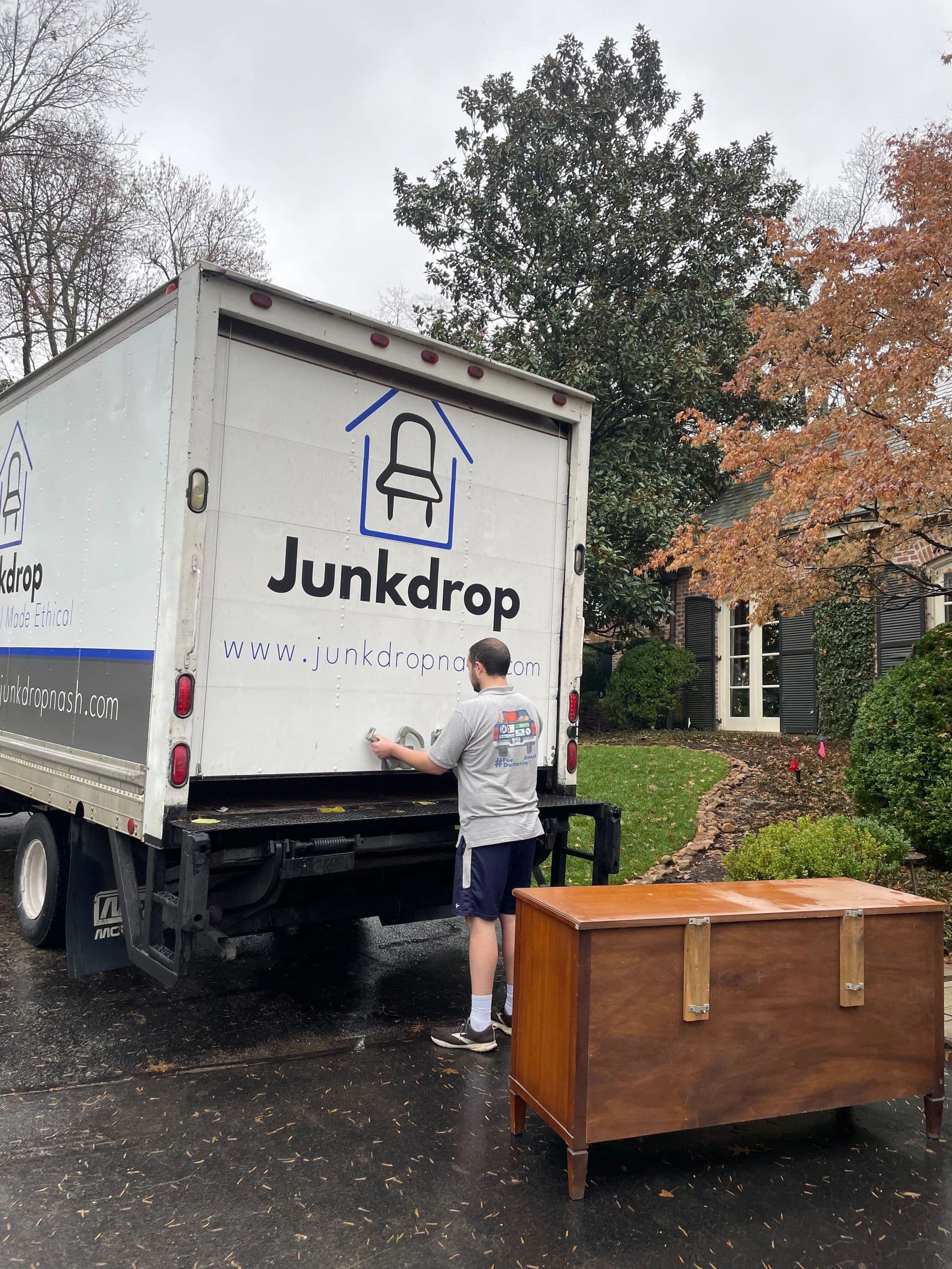 Junkdrop truck picking up furniture on a rainy day