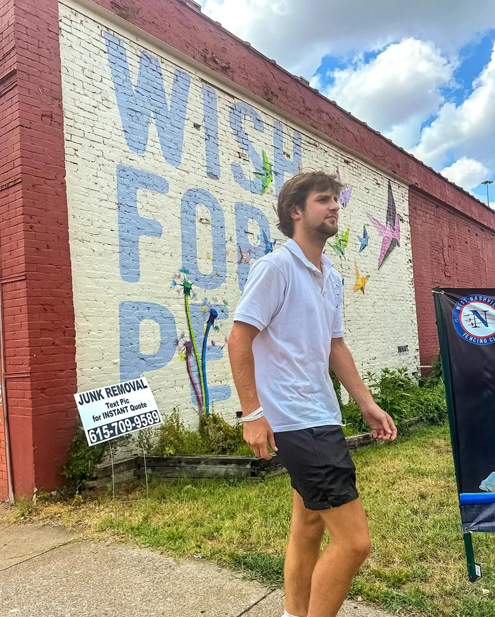 Junkdrop crew member outside a brick building