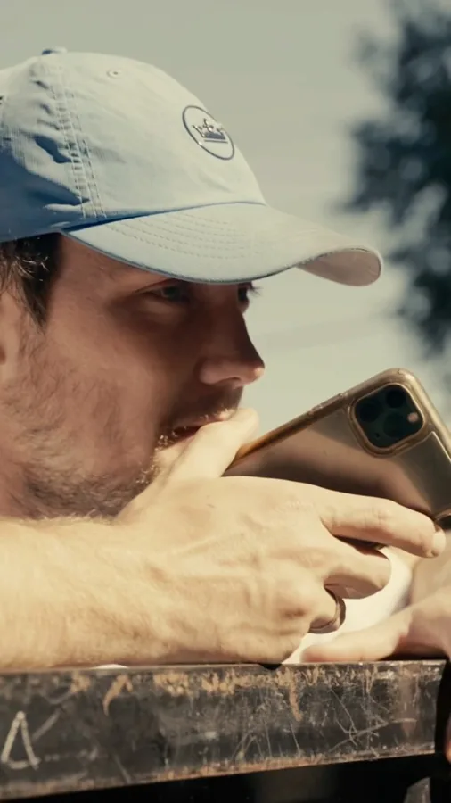 Crew member taking a phone call beside a Junkdrop truck